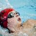 An Arkansas swimmer competes in the 100 meter backstroke at Canham Natatorium on Monday, July 29. Daniel Brenner I AnnArbor.com